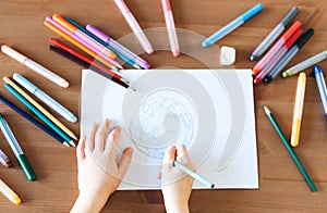 Child girl drawing with colorful pencils