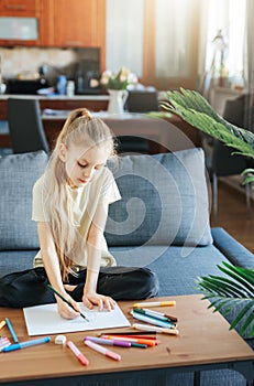 Child girl drawing with colorful pencils