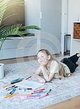 Child girl drawing with colorful pencils