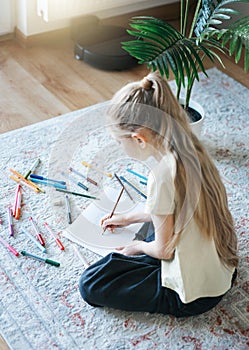 Child girl drawing with colorful pencils