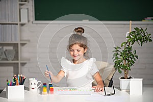 Child girl drawing with coloring pens paintind. Portrait of adorable little girl smiling happily while enjoying art and