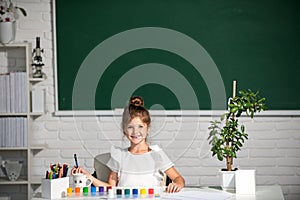 Child girl drawing with coloring pens paintind. Portrait of adorable little girl smiling happily while enjoying art and