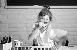 Child girl drawing with coloring pens paintind. Portrait of adorable little girl smiling happily while enjoying art and