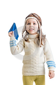 Child girl dressed as pilot playing with paper airplane isol