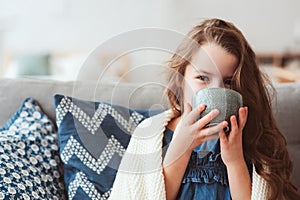 child girl drinking hot tea to recover from flu