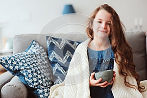 child girl drinking hot tea to recover from flu