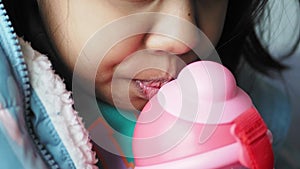 child girl drinking water sitting on sofa