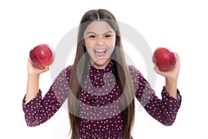 Child girl eating an apple over isolated white background. Tennager with fruit. Portrait of emotional amazed excited