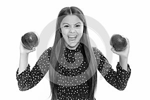 Child girl eating an apple over isolated white background. Tennager with fruit. Portrait of emotional amazed excited