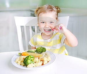 Child girl eating vegetables,healthy kid`s nutrition