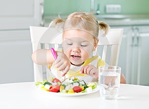 Child girl eating vegetables,kid`s nutrition