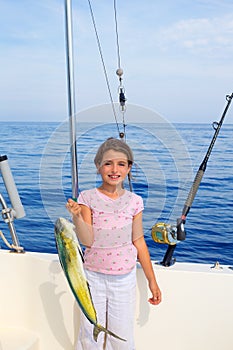 Child girl fishing in boat with mahi mahi dorado fish catch