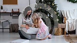 Child Girl Getting Christmas Dog Present from Mom