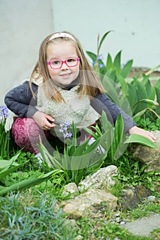 CHild girl with glasses in the garden