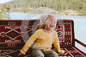 Child girl happy laughing emotional kid cute blonde hair baby outdoor 3 years old kid having fun