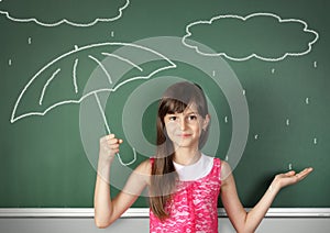 Child girl hold umbrella near school blackboard, weather concept