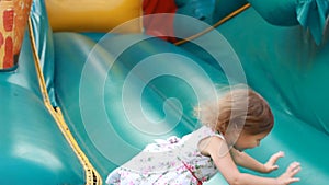 Child girl jumping on a trampoline and playing on playground for kids. Games for children.