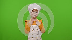 Child girl kid dressed as cook chef waving hands, asking to follow or join, welcome, hello gesture