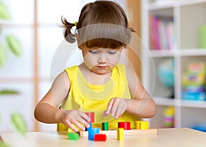 Child girl kid playing with sorter toys photo
