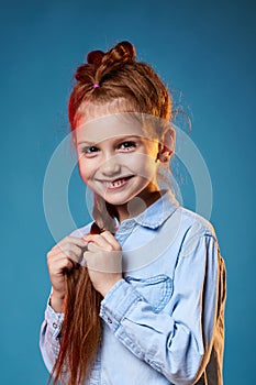 child girl with long red hair with creative braid hairdo