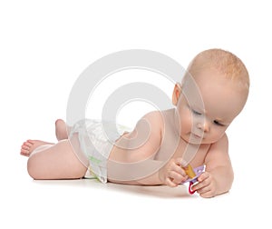Child girl lying with baby nipple soother photo