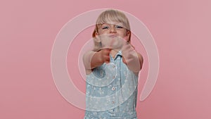 Child girl make playful silly facial expressions, parodies seal animal fooling around clapping hands