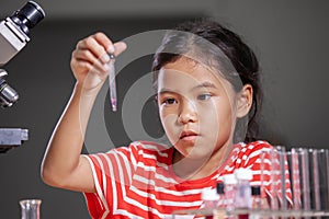 Child girl making chemical experiment in the laboratory