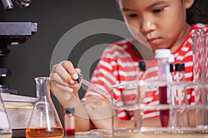 Child girl making chemical experiment in the laboratory