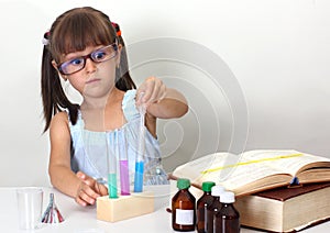 Child girl making science test