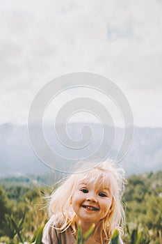 Child girl outdoor smiling face portrait cute baby 2 year old blond hair funny kid