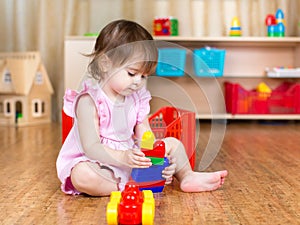 Child girl playing with block toys indoor