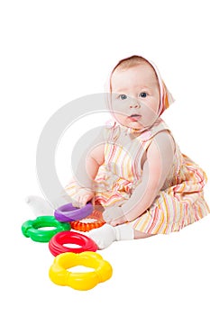 Child girl playing with toy pyramid isolated on white background