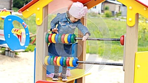 Child girl plays in the playground in different games. Entertainment for children.