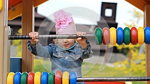 Child girl plays in the playground in different games. Entertainment for children.