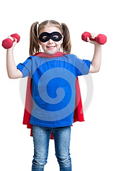 Child girl plays superhero and lifts dumbbells