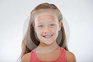 Child, girl and portrait or happiness in studio with confidence, positive attitude and carefree youth. Kid, face and