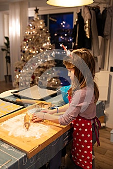 Child girl preparing cookies at Christmas