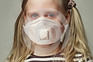 Child girl in protective medical mask crying, closeup portrait