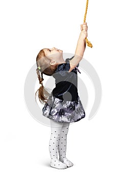 Child girl pulling a rope from top, isolated on white