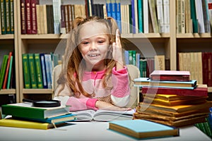 child girl raises her hand, knows the answers to all questions, erudite girl