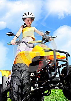 Child girl rides on quad