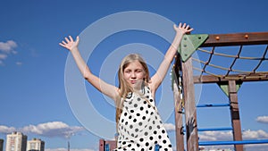 child girl rides on a swing at the playground