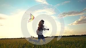 Child girl run with a kite in the park. Happy family freedom a kid dream concept. Child daughter running with their