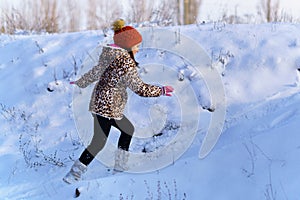 child girl runs and having fun in the winter forest  bright sunlight and shadows on the snow  beautiful nature