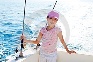 Child girl sailing in fishing boat holding rod