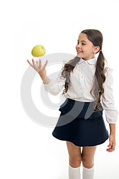 Child girl school uniform clothes toss apple. Girl cute pupil holds apple fruit white background. Child smart kid