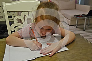 Child girl, schoolgirl doing homework.