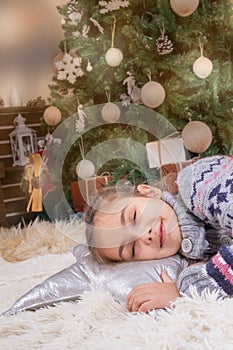 Child girl sleeping dream with happy emotions under Christmas de