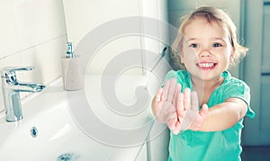 Child girl smiling face wahing and showing clean hands