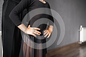 Child girl standing in black sport bodysuit in dancing studio during training posture. 4 5 years old preschool age